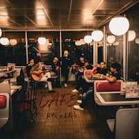 a group of people sitting at a table in a diner